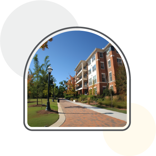 An apartment building with a sidewalk and trees