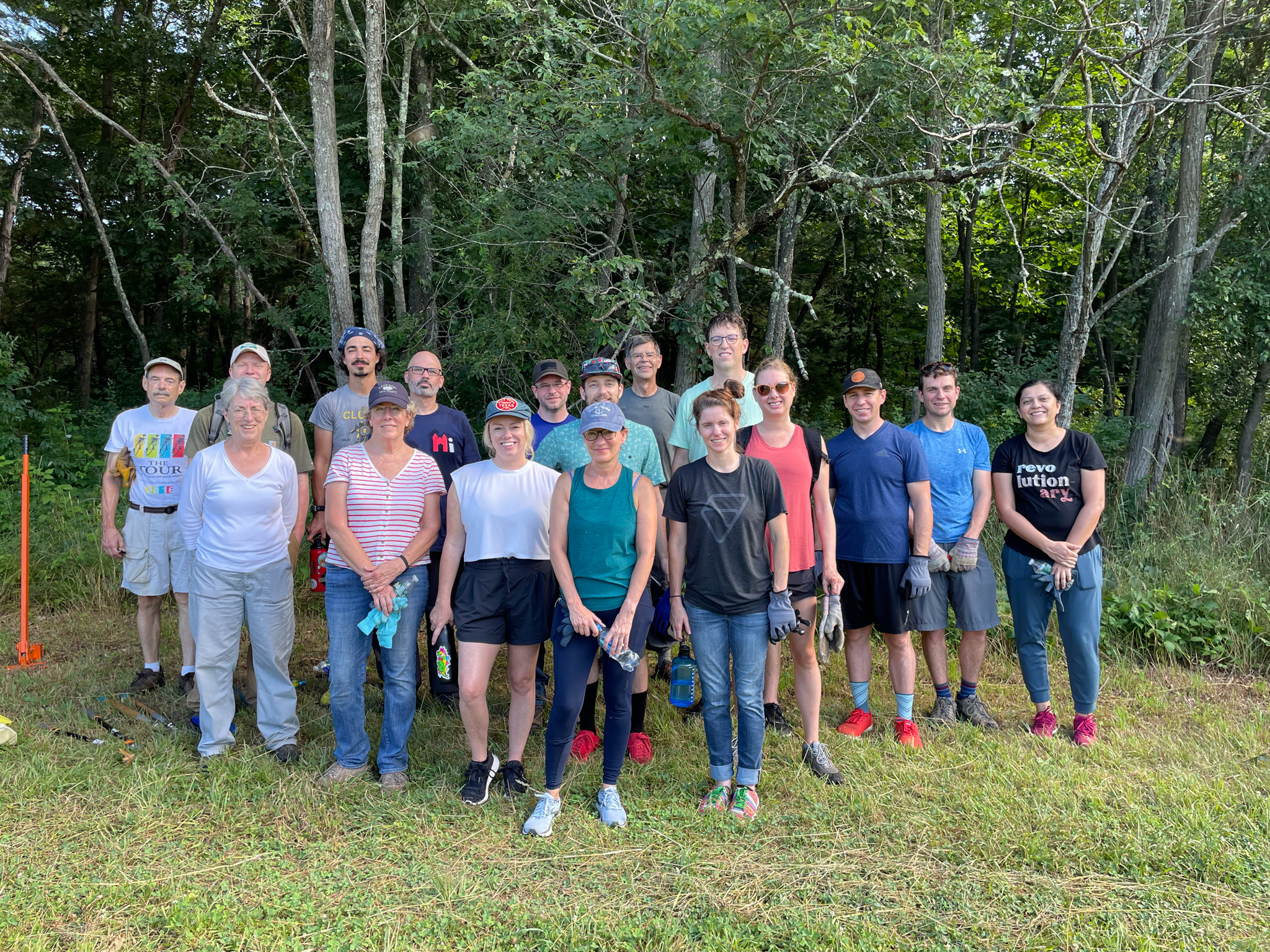 ZSuite Employees posing alongside three members of the Simsbury Land Trust at the edge of a Connecticut forest